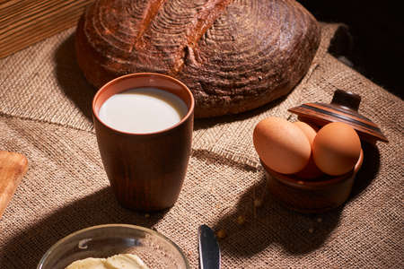 Assorted dairy products milk, cheese, eggs, rustic still life