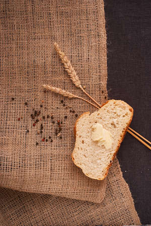 Frash assortment of baked bread on sacking background viewed from above