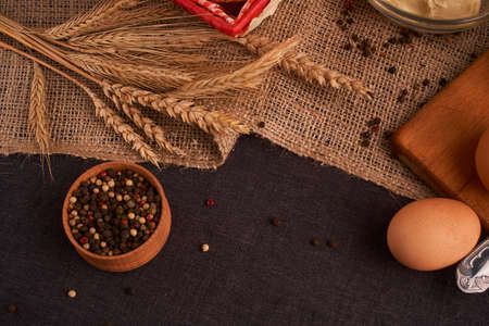 Peppercorns in a wooden bowl on table with food rustic styleの写真素材