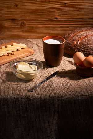 Assorted dairy products milk, cheese, eggs, rustic still life