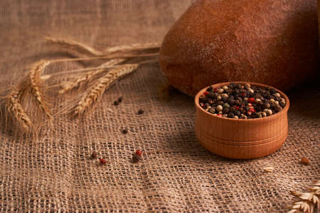 bowl of various pepper peppercorns seeds mix on rustic style backgroundの写真素材