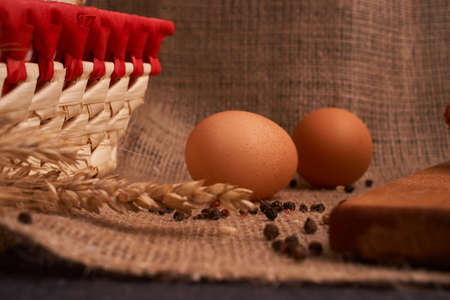 Eggs with bread and kitchen utensils on vintage wooden backgroundの写真素材