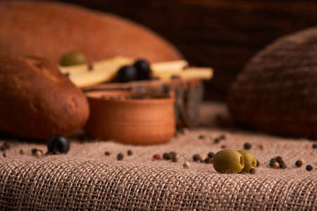 olive is on the table in background of bread, baguette and cheeseの写真素材