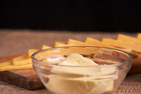 Butter and chees and milk for breakfast, over rustic wooden background with copy space.