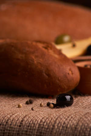 olive is on the table in background of bread, baguette and cheeseの写真素材
