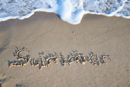 Summer message on the beach sandの写真素材