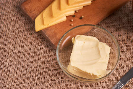 Butter and chees and milk for breakfast, over rustic wooden background with copy space.