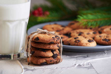 holidays, celebration and home concept - milk and cookies for Santa
