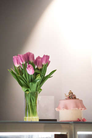 pink tulips in the vase on white background.の写真素材