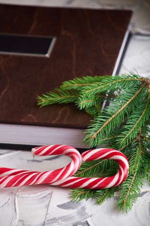 book with wooden cover and candy on white background. New Yearの写真素材