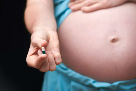 pregnant woman uses vitamins. treatment of pregnant women. pregnancy. Pregnant woman uses vitamin tablets for healthy nutritionの写真素材