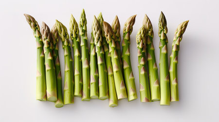 Fresh green asparagus spears on a white background, top viewの素材