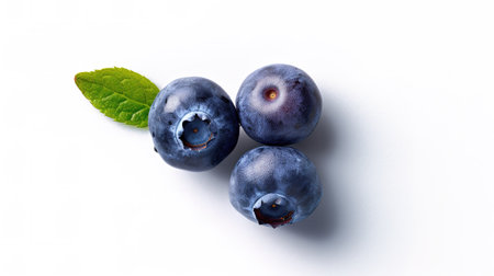 Blueberries with leaves isolated on a white background. Top view.の素材