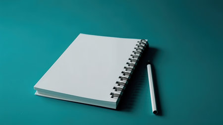 Notebook and pencil on a green background. Copy space for text.の素材