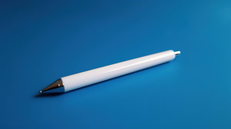 White pen on a blue background, close-up, selective focusの素材