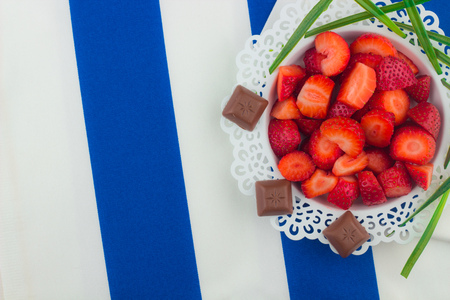Strawberries on a white plate / Red Freshly cut strawberries on a white artistic plateの写真素材