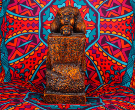 Ancient Egyptian Pharaoh Statue on colorful Artistic background / Ancient Egyptian pharaoh Statue on colorful oriental patternのeditorial素材