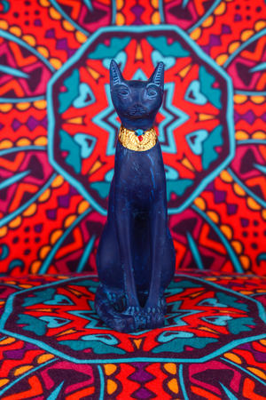 Ancient Egyptian Pharaoh Statue on colorful Artistic background / Ancient Egyptian pharaoh Statue on colorful oriental patternのeditorial素材