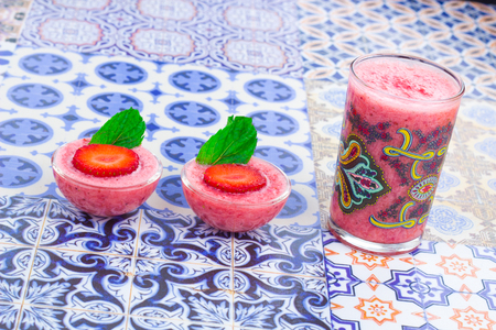 A cup of Strawberry Juice with mint leaves on an Oriental Colorful Backgroundの写真素材