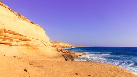 Seashore Waves and Mountain under the Sunshine in Matrouh, Egypt / View of Beautiful Seashore Waves and Majestic Mountain under the Sunshine in Matrouh, Egyptの写真素材
