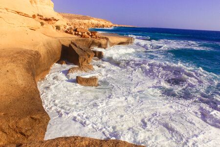 Seashore Waves and Mountain under the Sunshine in Matrouh, Egypt / View of Beautiful Seashore Waves and Majestic Mountain under the Sunshine in Matrouh, Egyptの写真素材