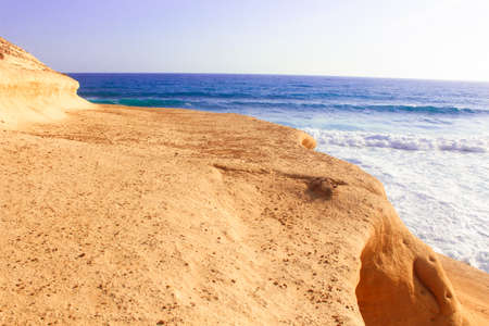 Seashore Waves and Mountain under the Sunshine in Matrouh, Egypt / View of Beautiful Seashore Waves and Majestic Mountain under the Sunshine in Matrouh, Egyptの写真素材