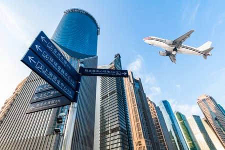 the airplane with the city scene background in Shanghai Chinaのeditorial素材