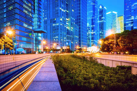 The light trails on the modern building background in shanghai china.