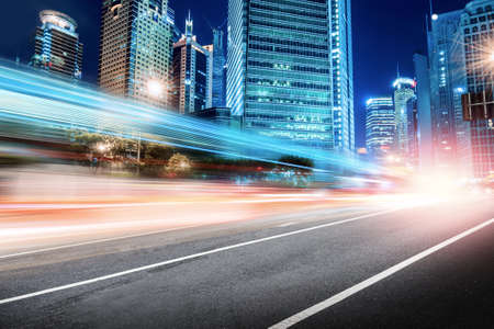 The light trails on the modern building background in shanghai china.の写真素材