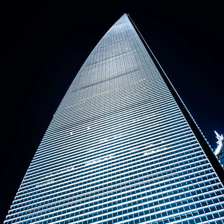 Panoramic and perspective wide angle view to steel blue background of glass high rise building...