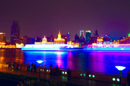 Shanghai historic architecture panorama at night lit by lights over Huangpu Riverの写真素材