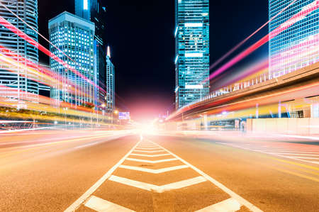 The light trails on the modern building background in shanghai china.の写真素材