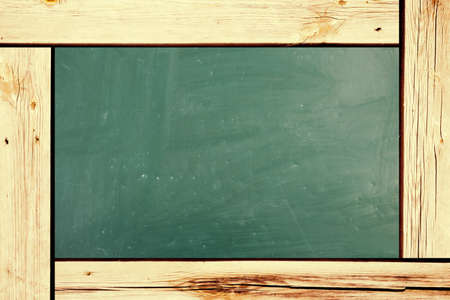 Chalkboard blackboard with frame isolated. Black chalk board texture empty blank with chalk traces and wooden frame. Square.の写真素材