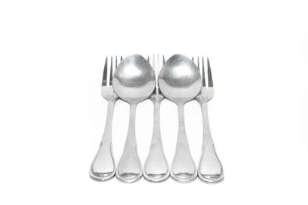 spoon and fork tight together with white paperの写真素材