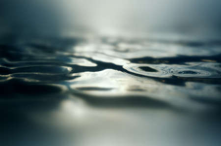 An abstract water surface background with some ripples on it.の写真素材