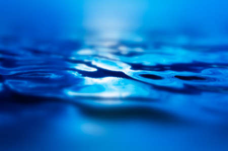 An abstract water surface background with some ripples on it.の写真素材