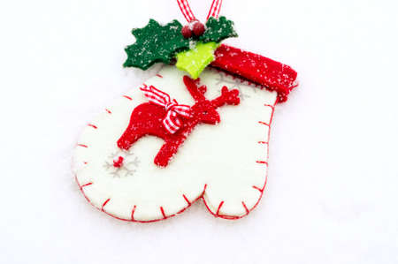 A christmas background with a christmas glove on snow.
