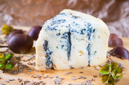 A piece of an amazing fresh blue cheese on a wood board.の写真素材