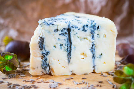 A piece of an amazing fresh blue cheese on a wood board.の写真素材