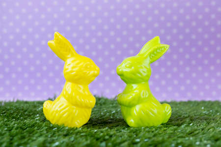 A couple of colorful Easter bunnies on the artificial grass.の写真素材