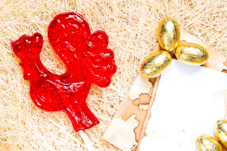 A red rooster lollipop with golden eggs background. The rooster is a symbol of 2017 and a sign of the Chinese horoscope.の写真素材