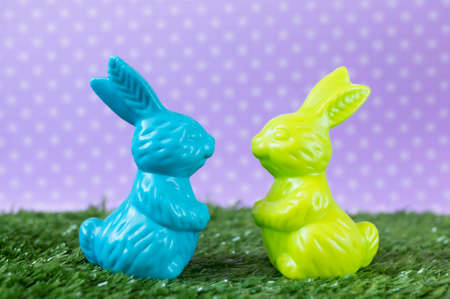Cute colorful Easter bunnies on the artificial grass.の写真素材