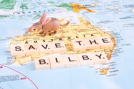 MAGNITOGORSK, RUSSIA - JUNE 09, 2017: A photo with a toy bilby and letters on the map. Save the bilby concept.のeditorial素材