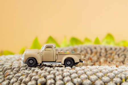 A little toy farm pickup truck on sunflower seeds.の写真素材