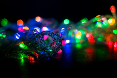 A colorful background with glowing Christmas garland. Selective focus.の写真素材