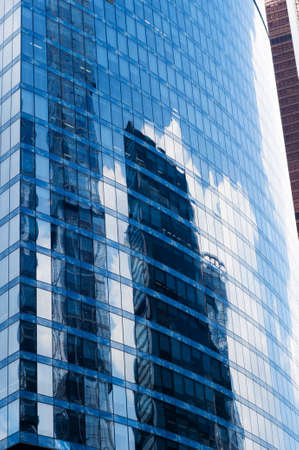 MOSCOW, RUSSIA - JULY 04, 2016: Clouds, sky and buildings are reflecting in the windows of Naberezhnaya Tower in Moscow International Business Center.のeditorial素材