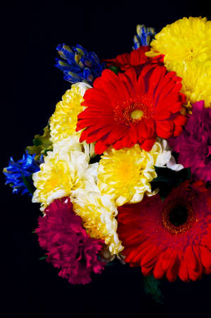 A photo of a bunch of colorful flowers against a black background. Selective focus.の写真素材
