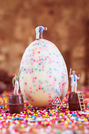 Toy painters are decorating an Easter egg. Toy concept for Easter.の写真素材