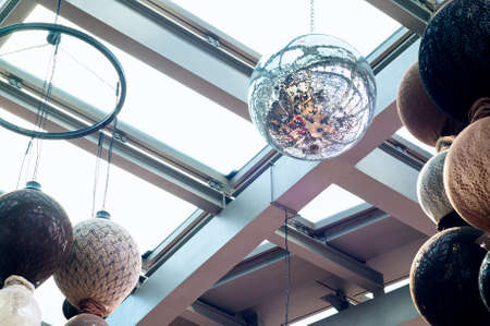 Photo of a giant disco ball and other decorations on the ceiling. Selective focus.の写真素材