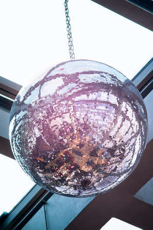 Photo of a giant disco ball on the ceiling. Selective focus.の写真素材